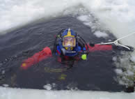A trained Fremont Police Officer practicing ice diving operations
